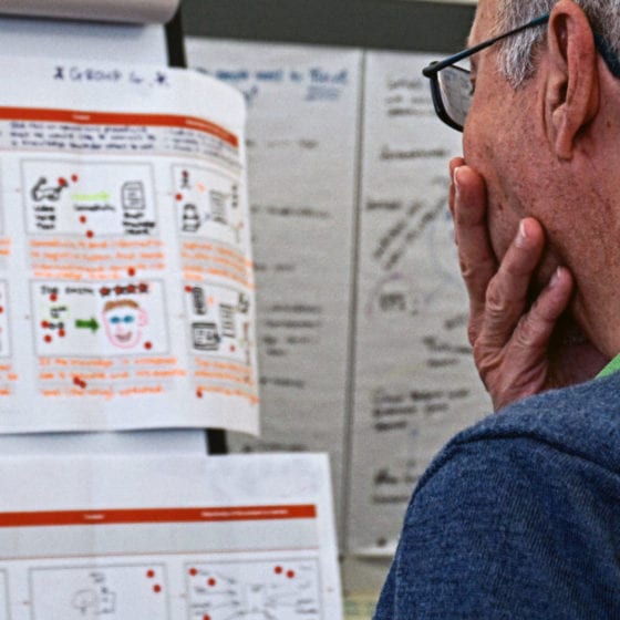 man looking at workshop outputs