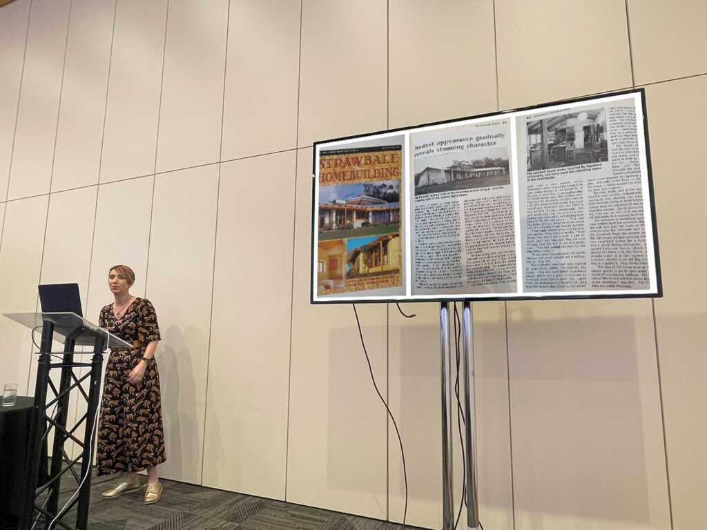 Katja standing at a podium presenting her presentation.