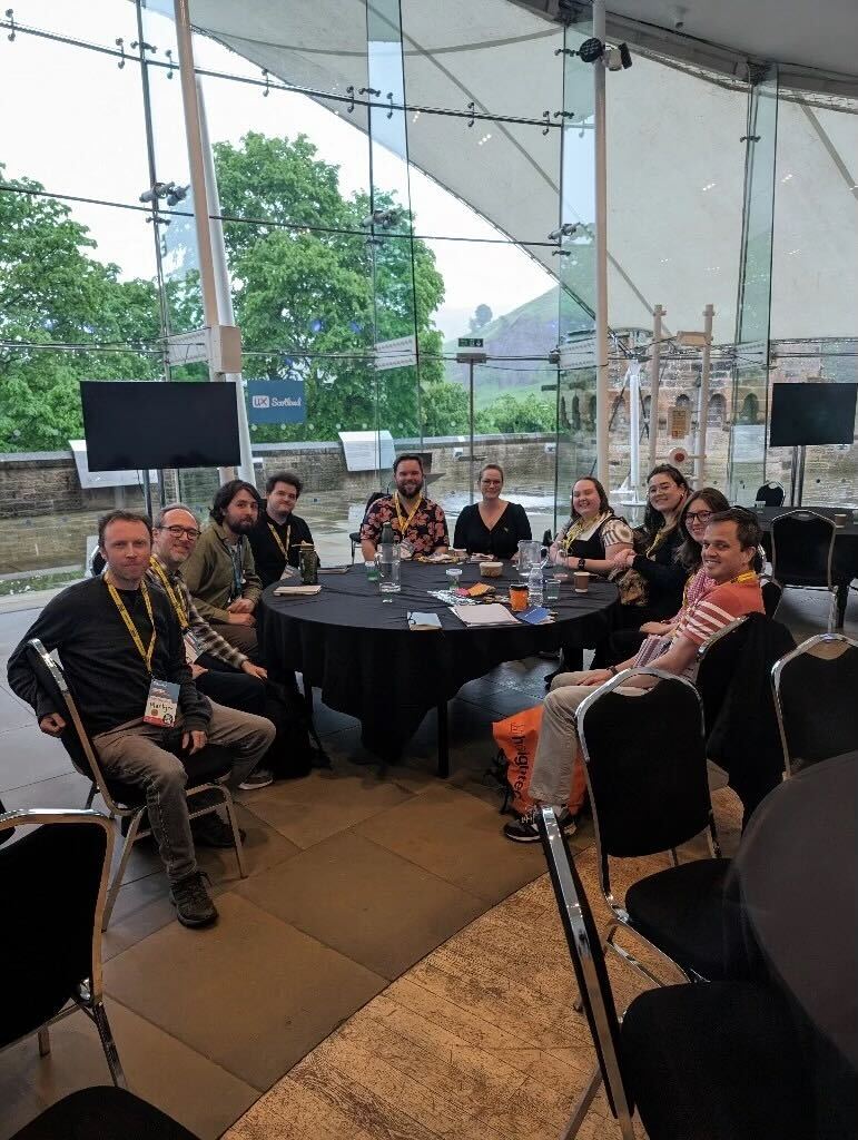 A group of people sitting around a table after a discussion.